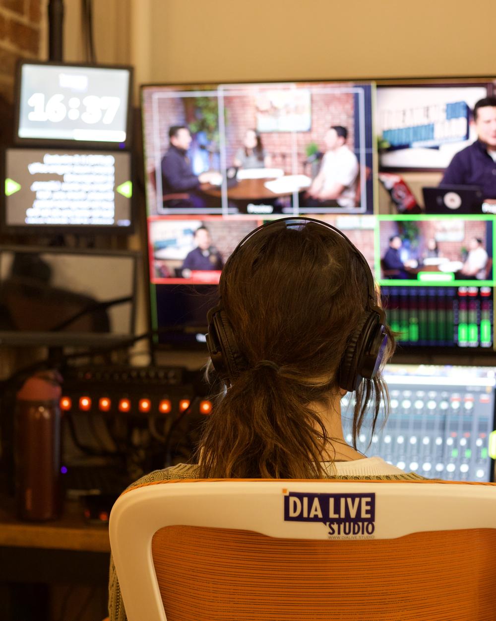 Operator in the control room watching the multiview with headphones on