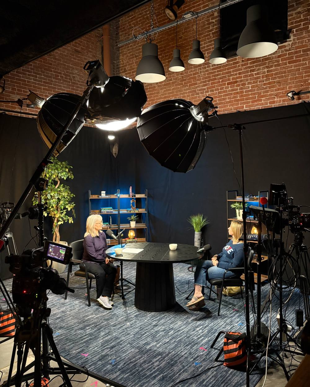 Two-person conversation set under pendant lights on the black backdrop